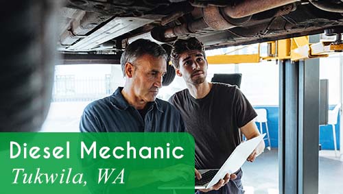 Two male mechanics work under a vehicle. White text over a green banner reads: 'Diesel Mechanic in Tukwila, WA'. Apply now with All StarZ Staffing.