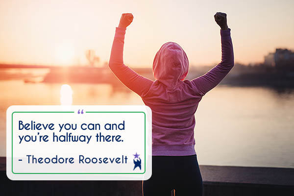 Image shows a woman from the back. She is wearing a pink hoodie and has her arms raised in a strength pose. There us an urban water scene in the background. Text reads: "Believe you can and you're halfway there" - Theodore Roosevelt. All StarZ Staffing.