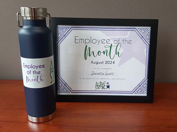 Framed Employee of the Month certificate and Employee of the Month water bottle, celebrating Zanetta for her outstanding performance at All StarZ Staffing.