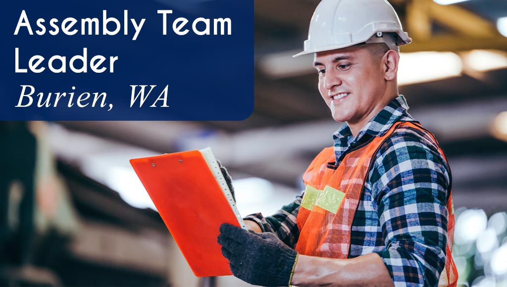 Photo of a Production Team Lead wearing safety gear and holding a clipboard. White text over a blue banner reads: 'Assembly Team Lead in Renton, WA.