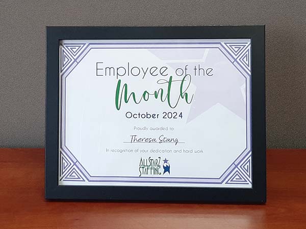 Framed Employee of the Month certificate, celebrating Theresa for her outstanding performance at All StarZ Staffing.